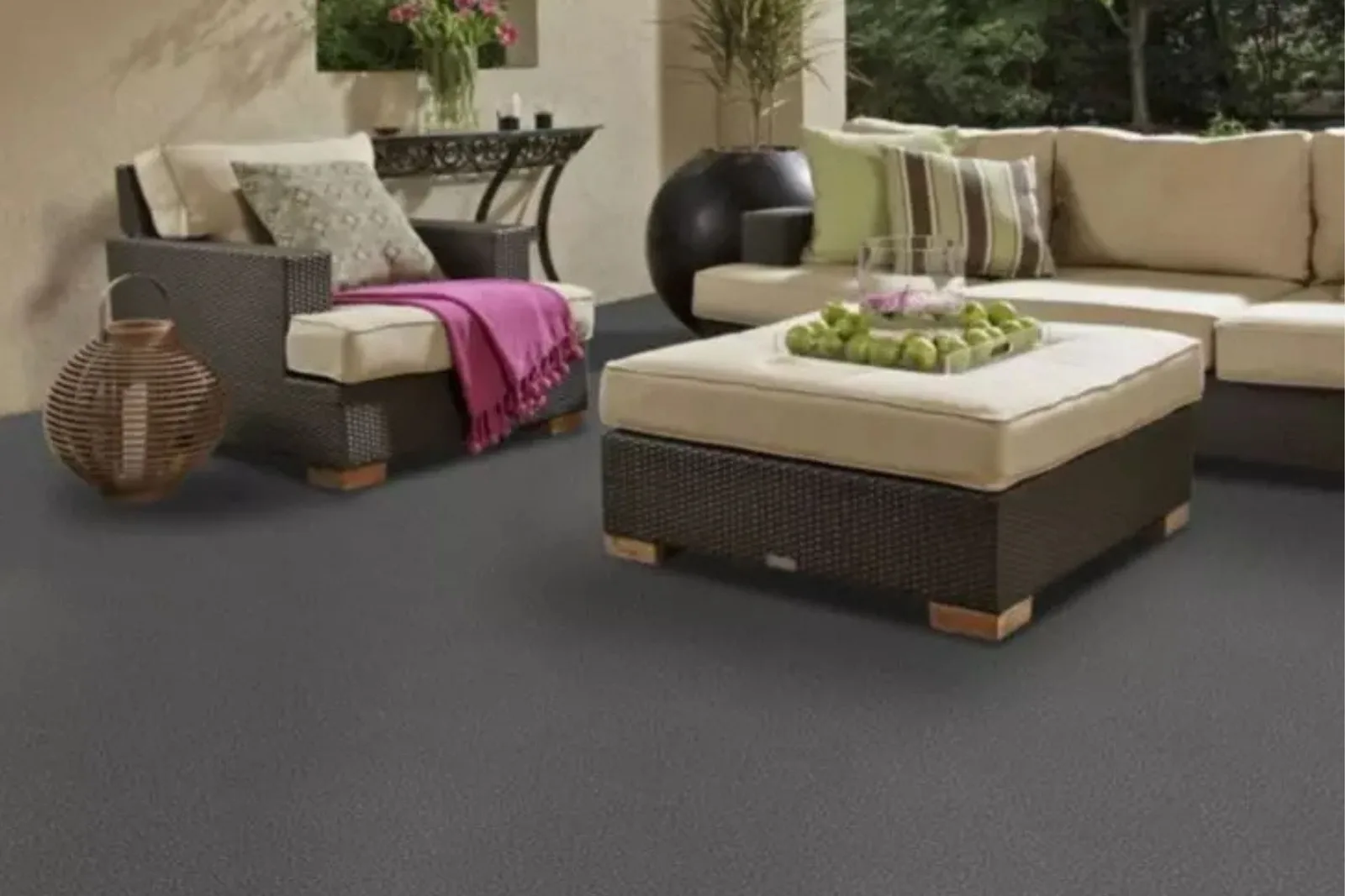 Gray outdoor carpet under wicker patio furniture on a covered porch
