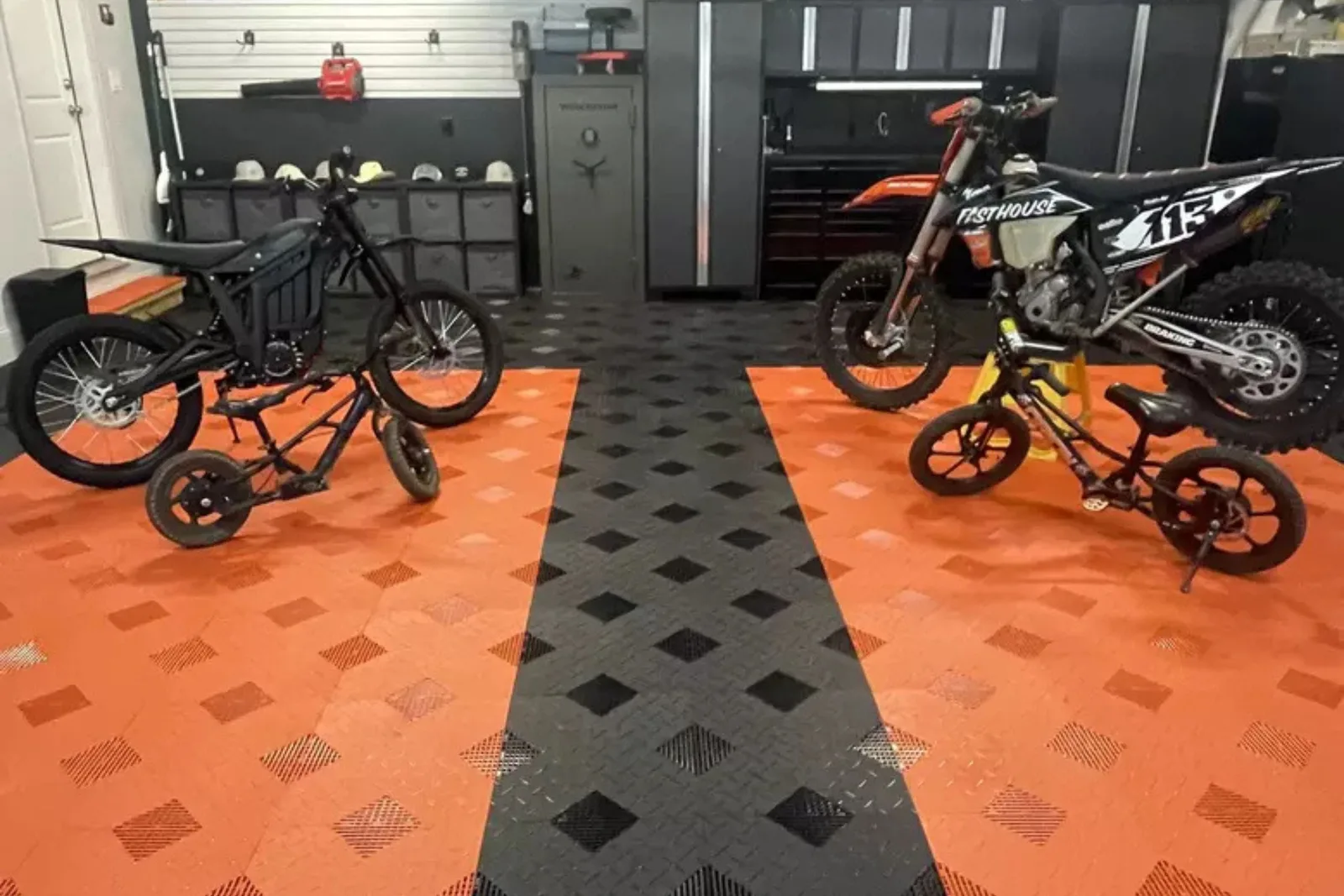 Dirt bikes on orange and black rigid garage floor tiles