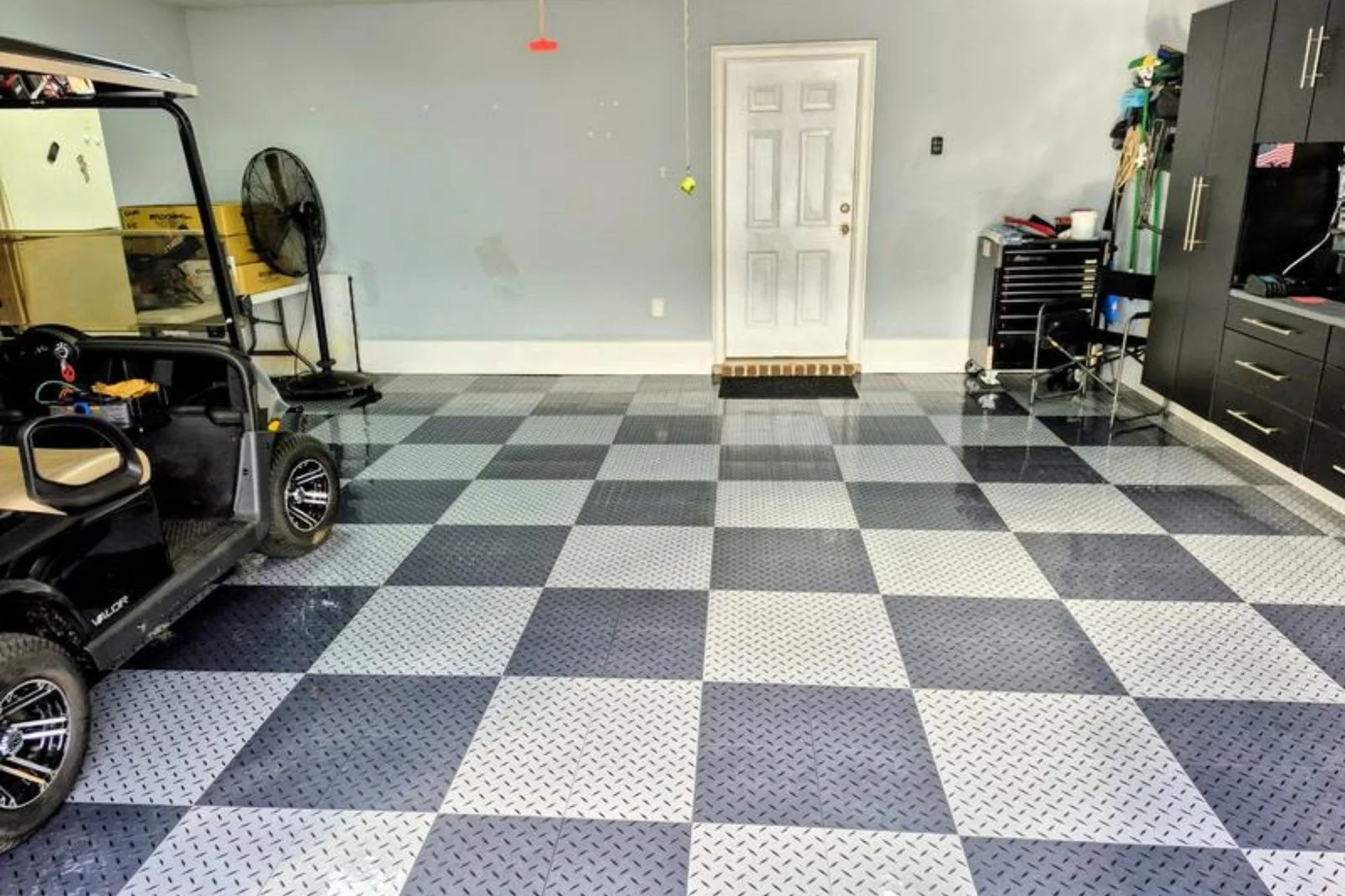 Golf cart on gray and black checkerboard Nitro Pro garage floor tiles