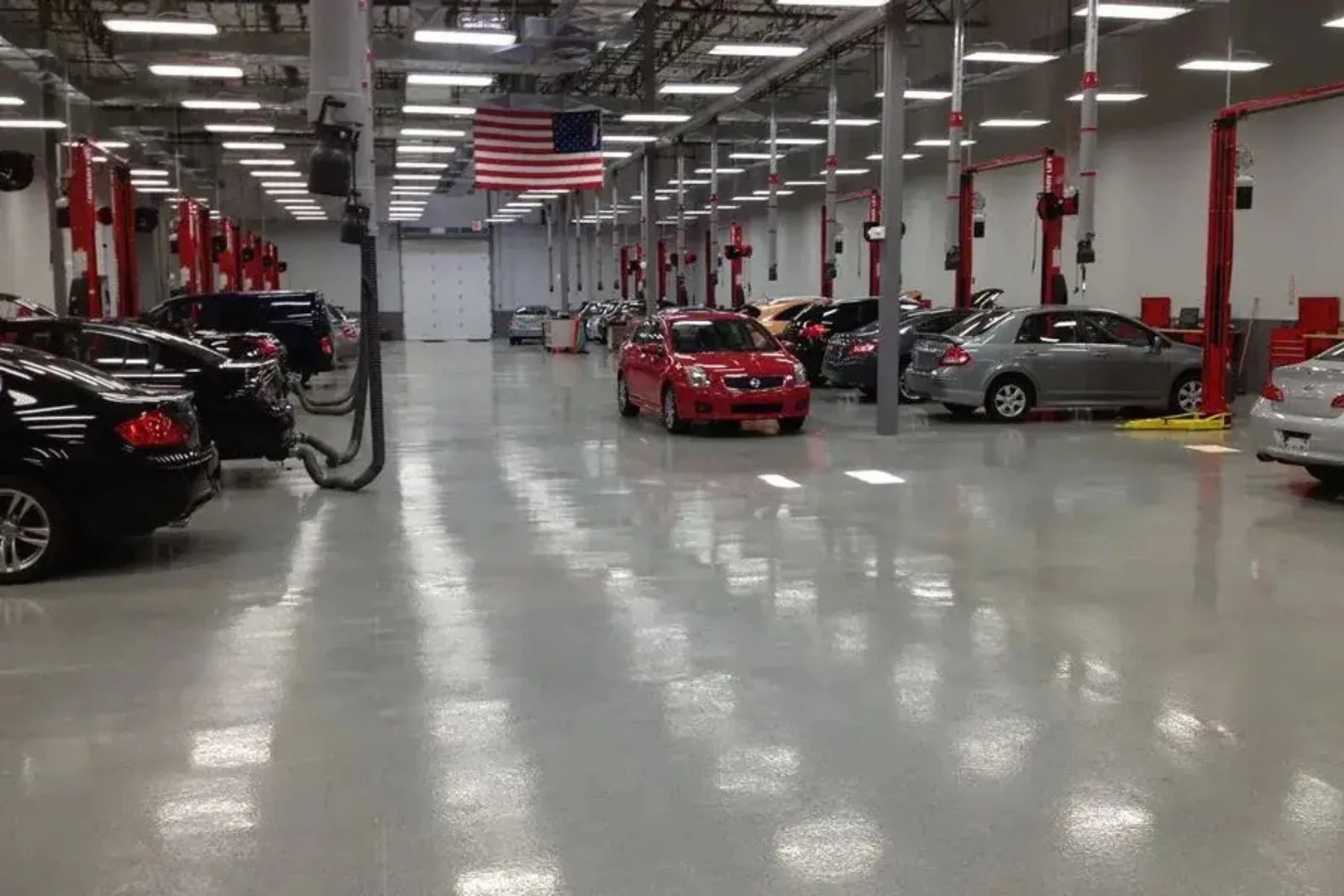 Auto service shop with cars on a glossy epoxy-coated floor