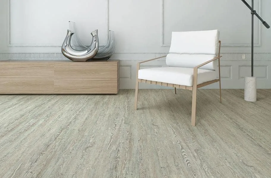 SPC vs. WPC: Gray wood-look SPC vinyl flooring in a living room setting.