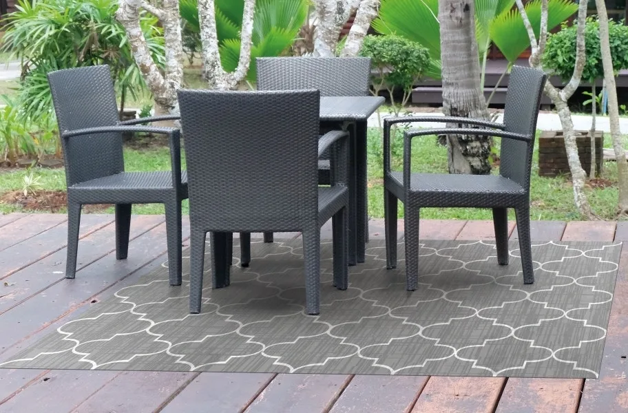 Greco Outdoor Area Rug on a patio.