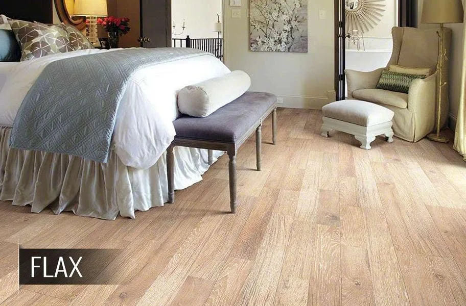Shop wood-look laminate floors Shaw reclaimed wood-look laminate flooring in a bedroom setting