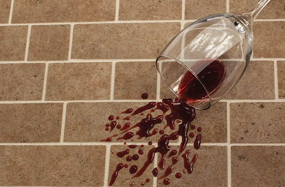 Sealed grout resisting a wine stain.