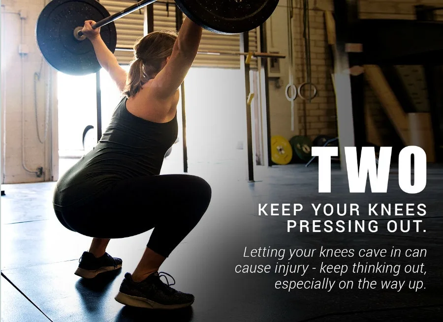 Two: keep your knees pressing out - woman in an overhead squat