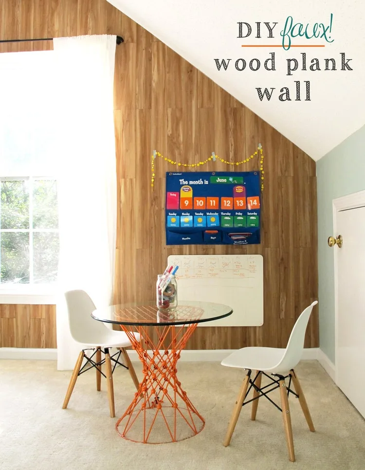 DIY faux wood plank wall behind a kids table and chairs