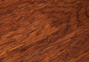 Close-up of durable dark wood-look vinyl plank flooring with a rich wood grain, a water-resistant and easy-to-clean alternative to traditional hardwood.