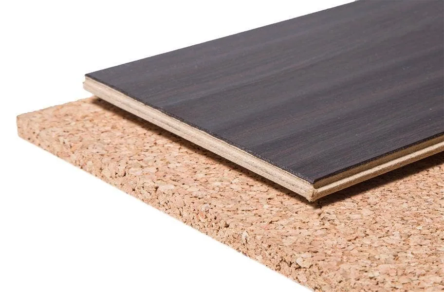 Dark engineered plank resting on a natural cork underlayment sheet