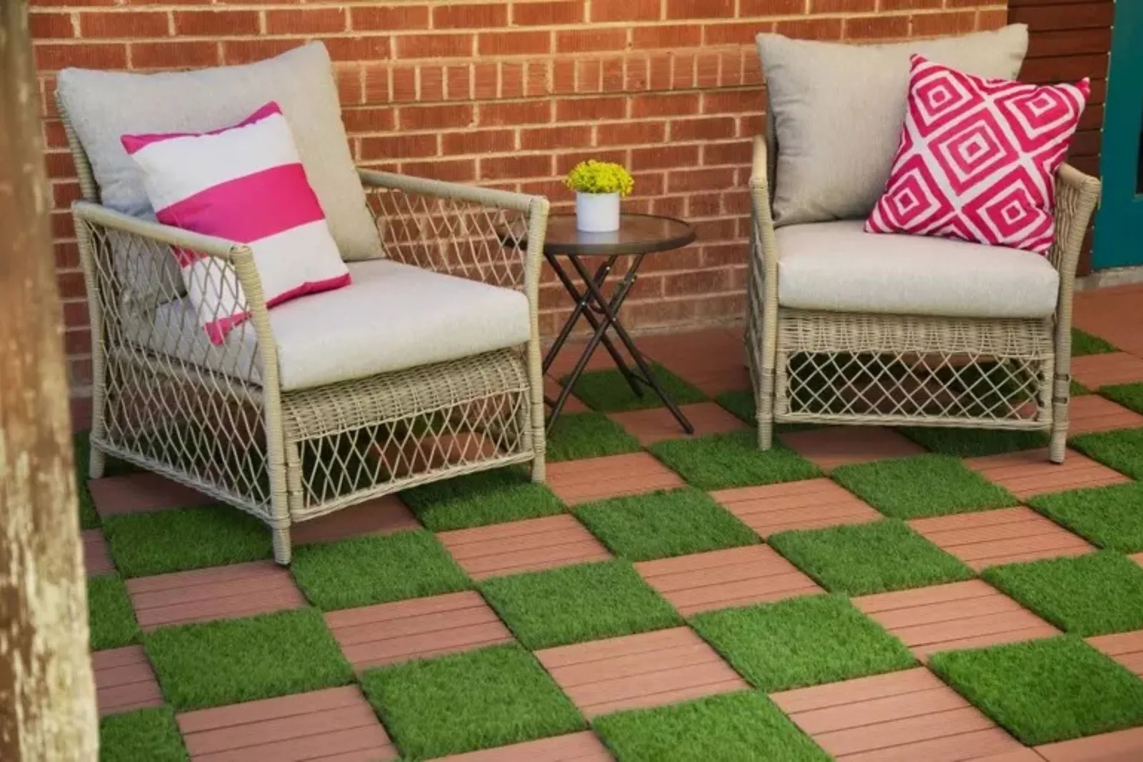 Artificial grass and composite deck tiles create a unique and stylish checkerboard pattern, offering a low-maintenance, comfortable, and durable flooring solution for an outdoor patio.