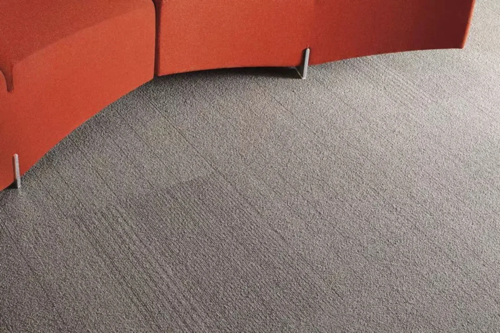 Close-up of a durable gray commercial carpet with subtle stripes, ideal for high-traffic office and business environments.