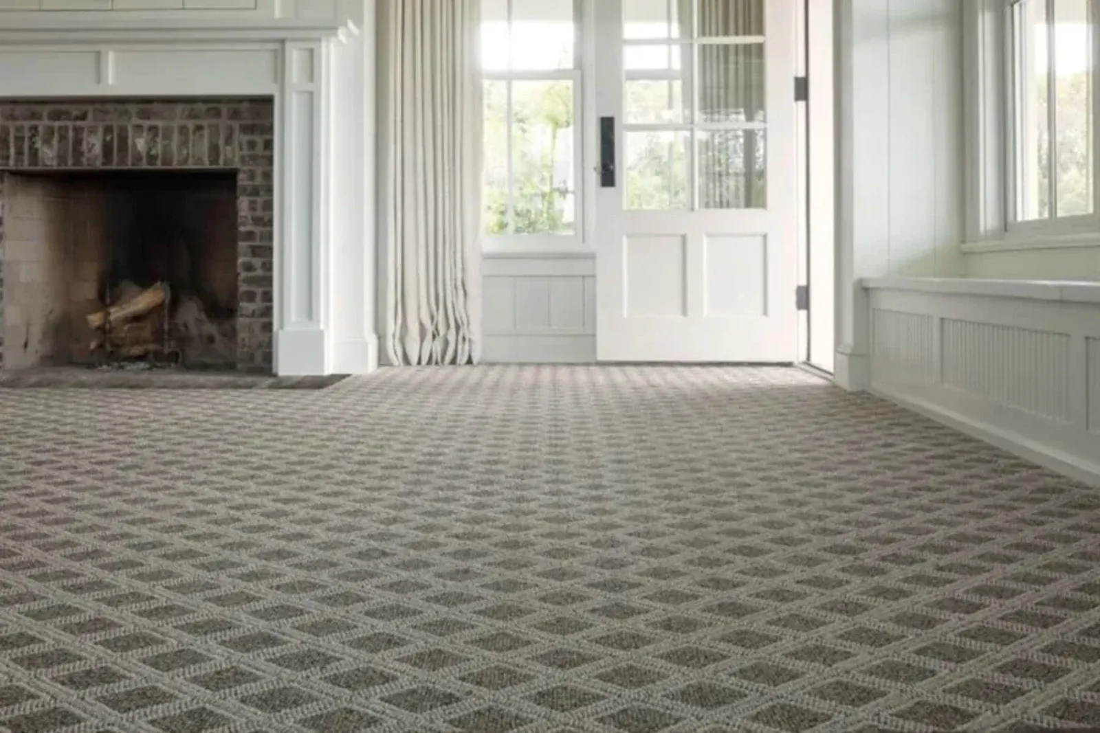 Bright, inviting living room with a durable tan diamond-patterned carpet, a cozy and stylish flooring solution.