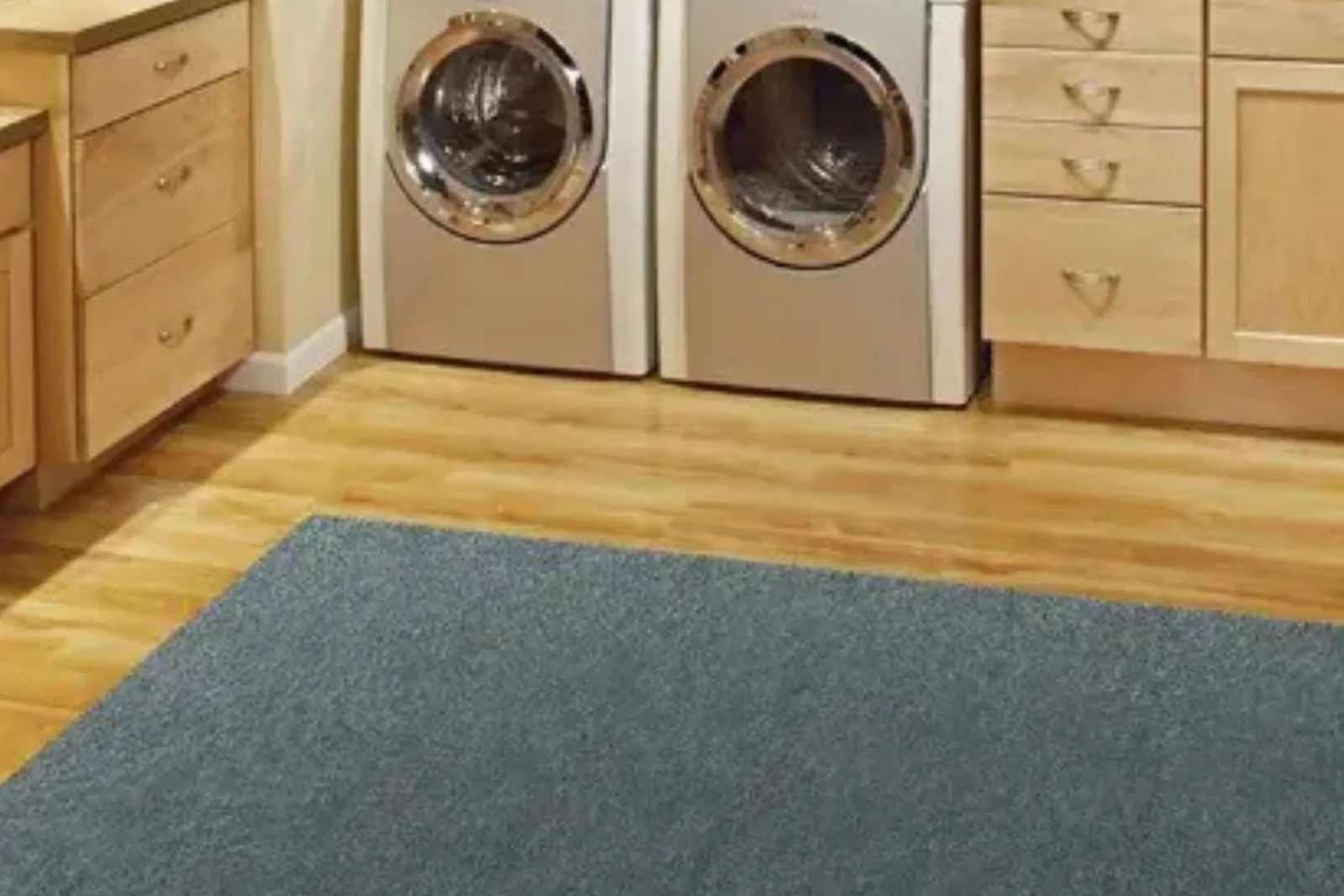 Laundry room with light wood flooring and a durable dark gray area rug, a practical and stylish choice for high-traffic areas.
