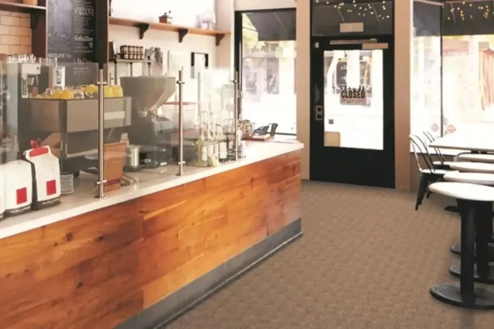 Stylish coffee shop with a durable commercial carpet in a tan-brown tone, ideal for high-traffic business environments.