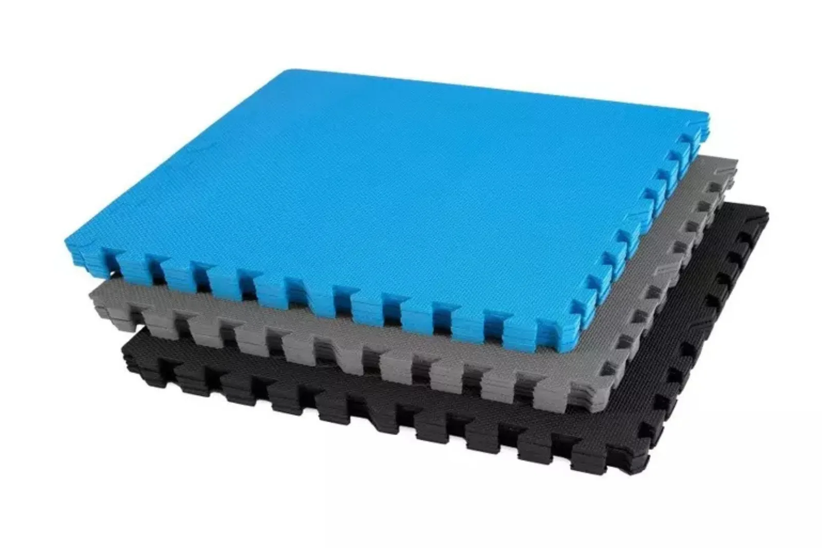 Thick interlocking foam mats in blue, gray, and black, stacked to show the thickness and texture, commonly used as cushioned martial arts mat flooring or gym flooring