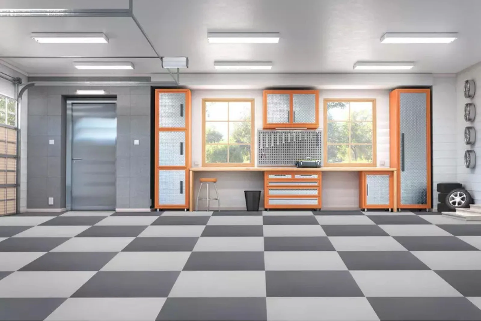 A clean, modern garage featuring a gray and white checkerboard garage floor. The interlocking garage tiles create a durable, non-slip surface that protects the concrete and provides a sleek, professional look for this organized workshop space with orange