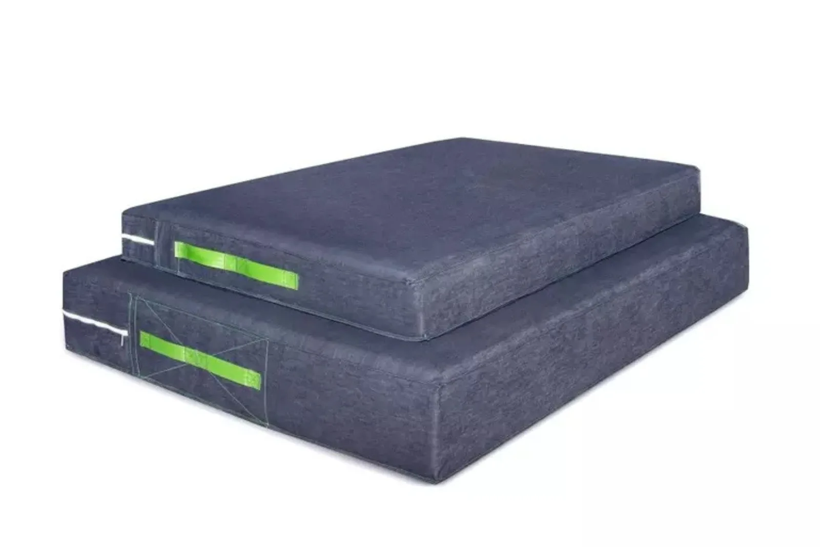 Skill pillow or crash mats in dark gray are stacked, providing thick, shock-absorbent safety mats essential for high-impact wrestling and martial arts training.