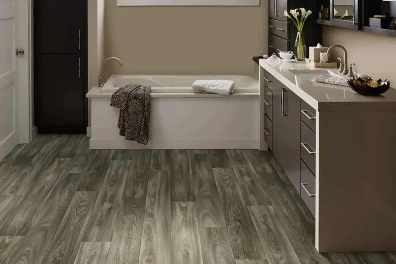 Modern bathroom with durable gray wood-look vinyl plank flooring, a water-resistant and stylish alternative to hardwood for wet areas.