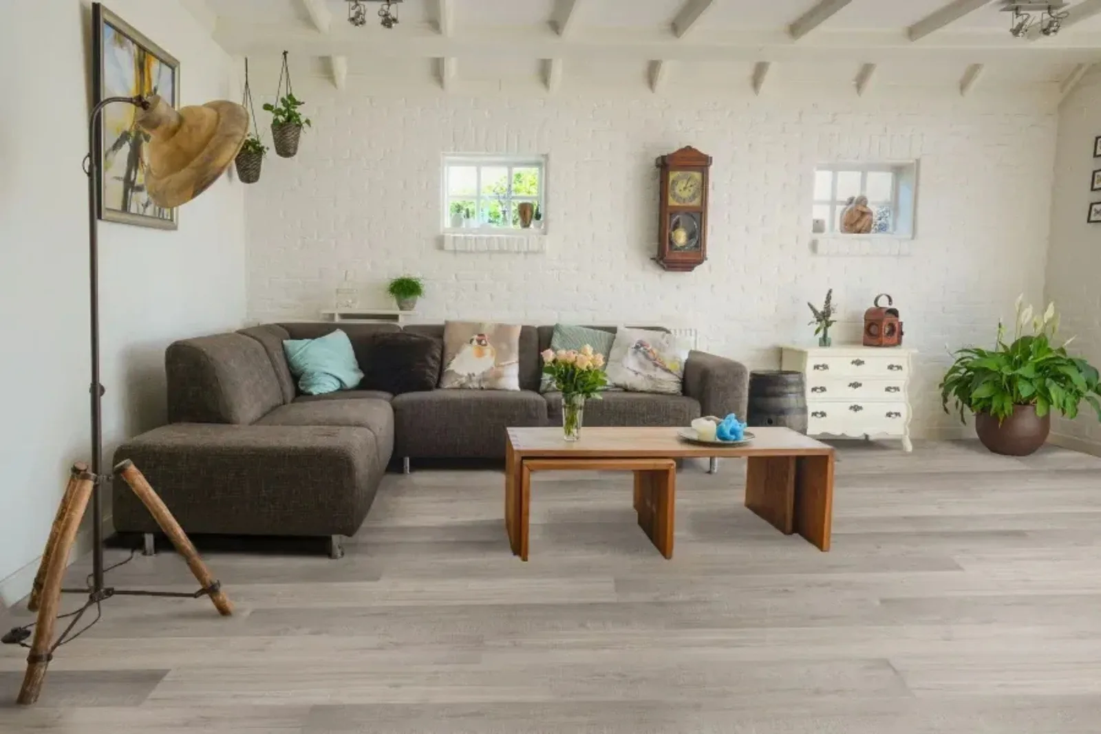 Bright living room with durable light gray wood-look vinyl plank flooring, a stylish and water-resistant alternative to hardwood.