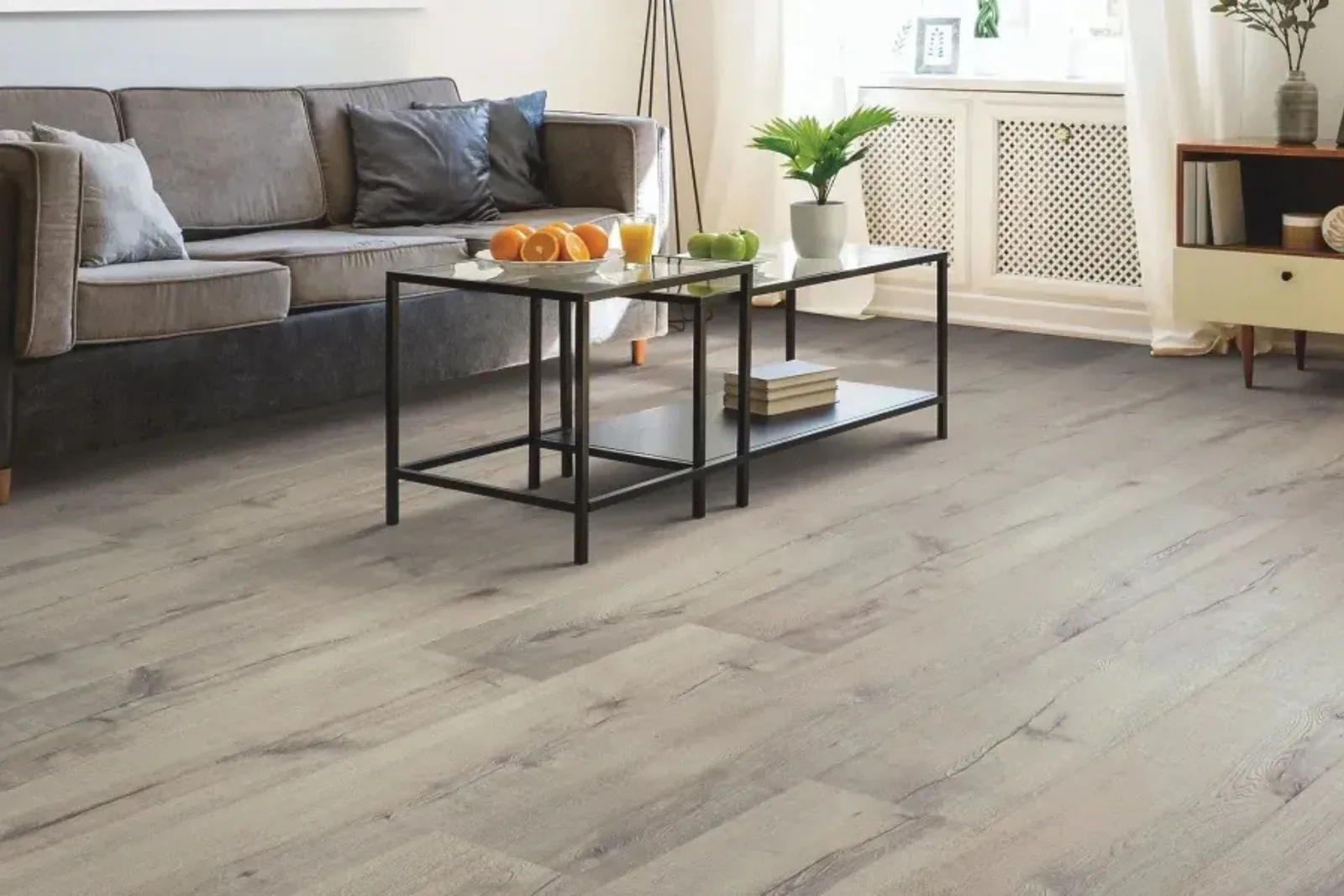 Modern living room with durable gray wood-look vinyl plank flooring, a water-resistant and easy-to-clean alternative to hardwood.