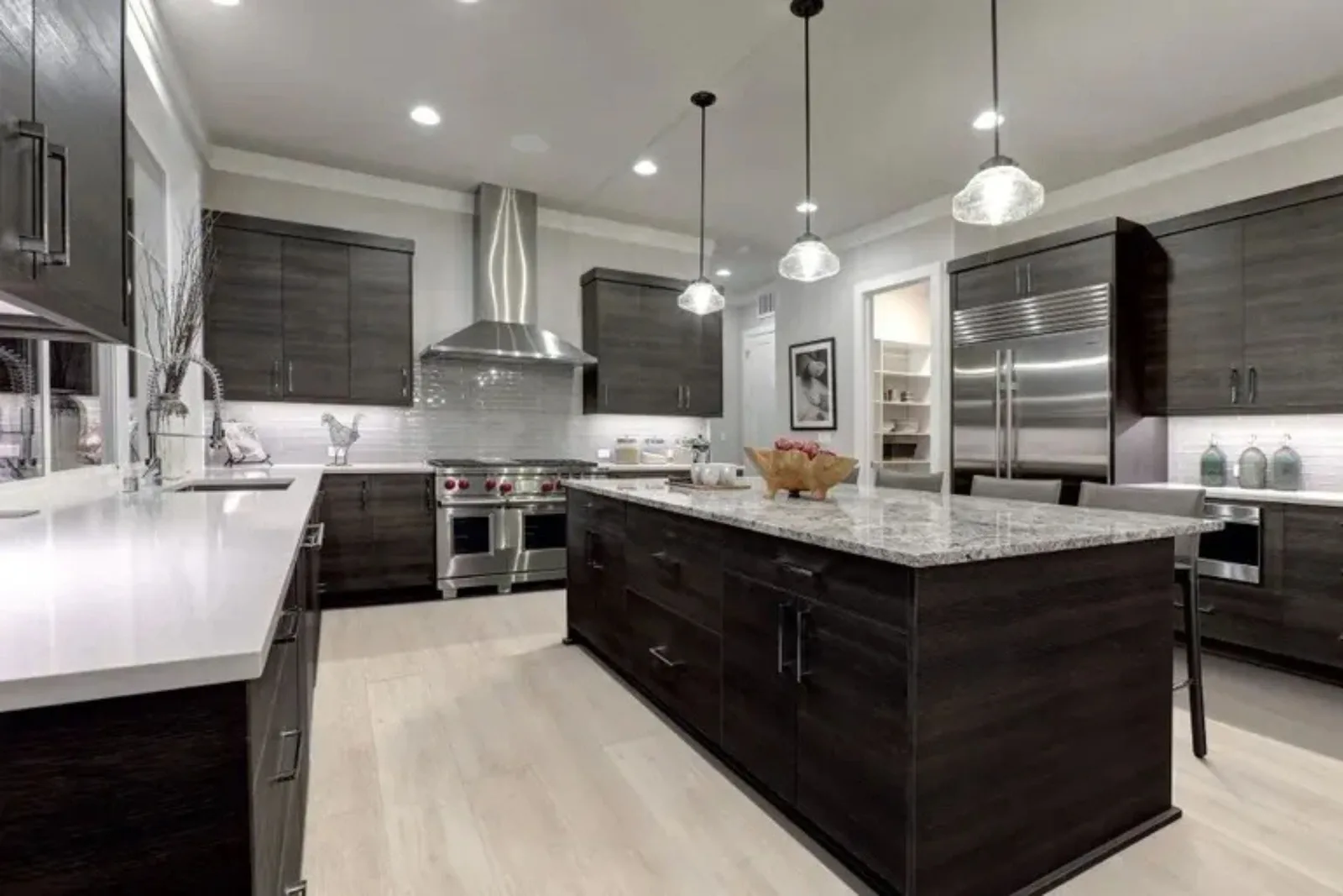 Modern kitchen with durable light gray wood-look vinyl plank flooring, a water-resistant and easy-to-clean alternative for a residential space.