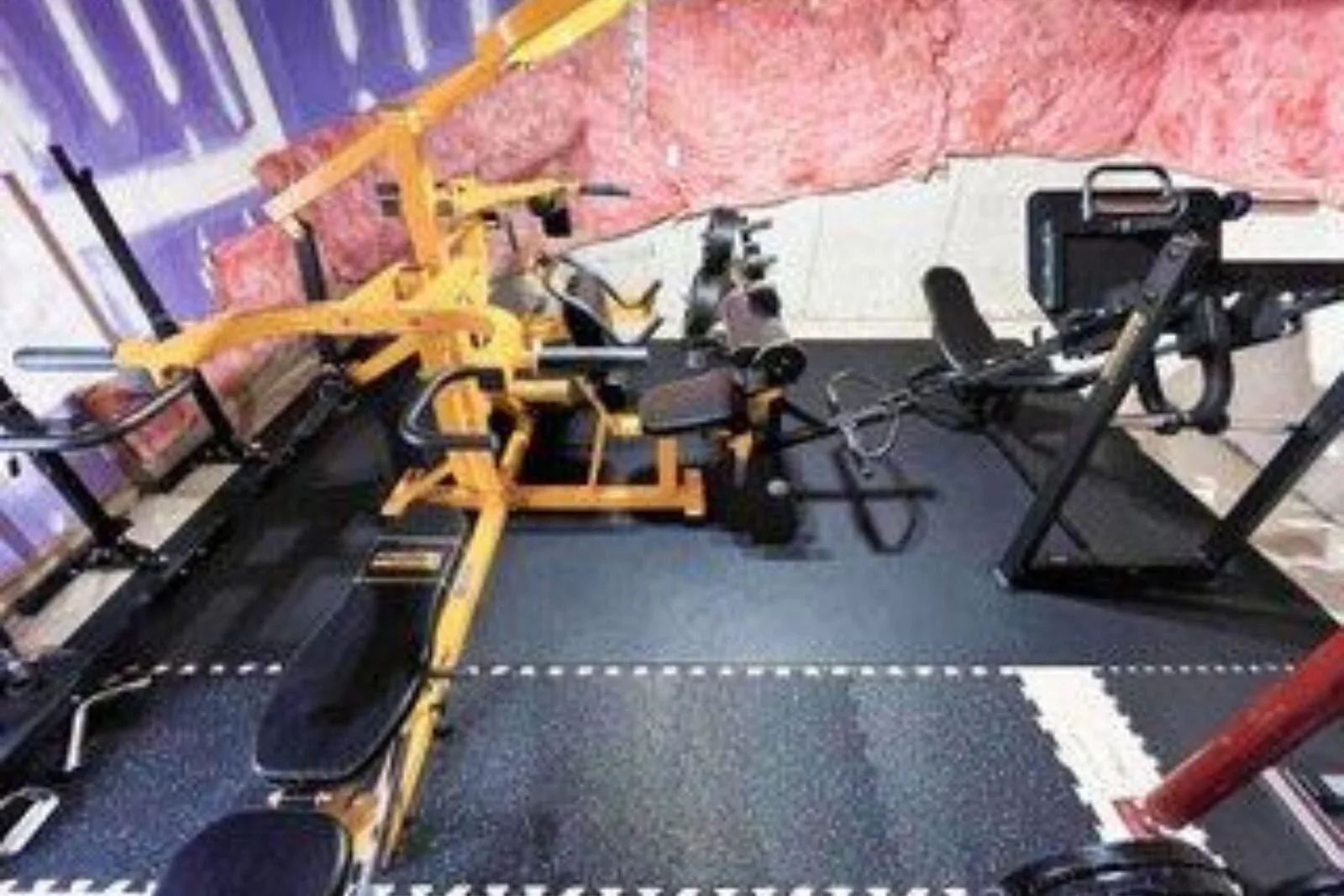 Home gym with durable black and gray interlocking foam floor tiles, a high-performance and shock-absorbing flooring solution for a residential workout space.