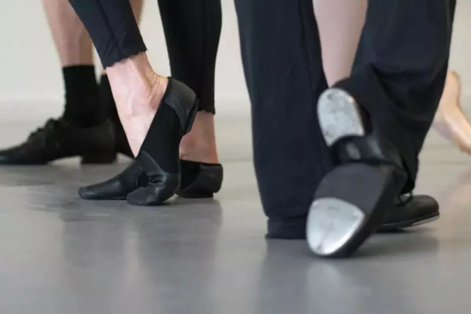 Dance shoes on gray adagio rolls.