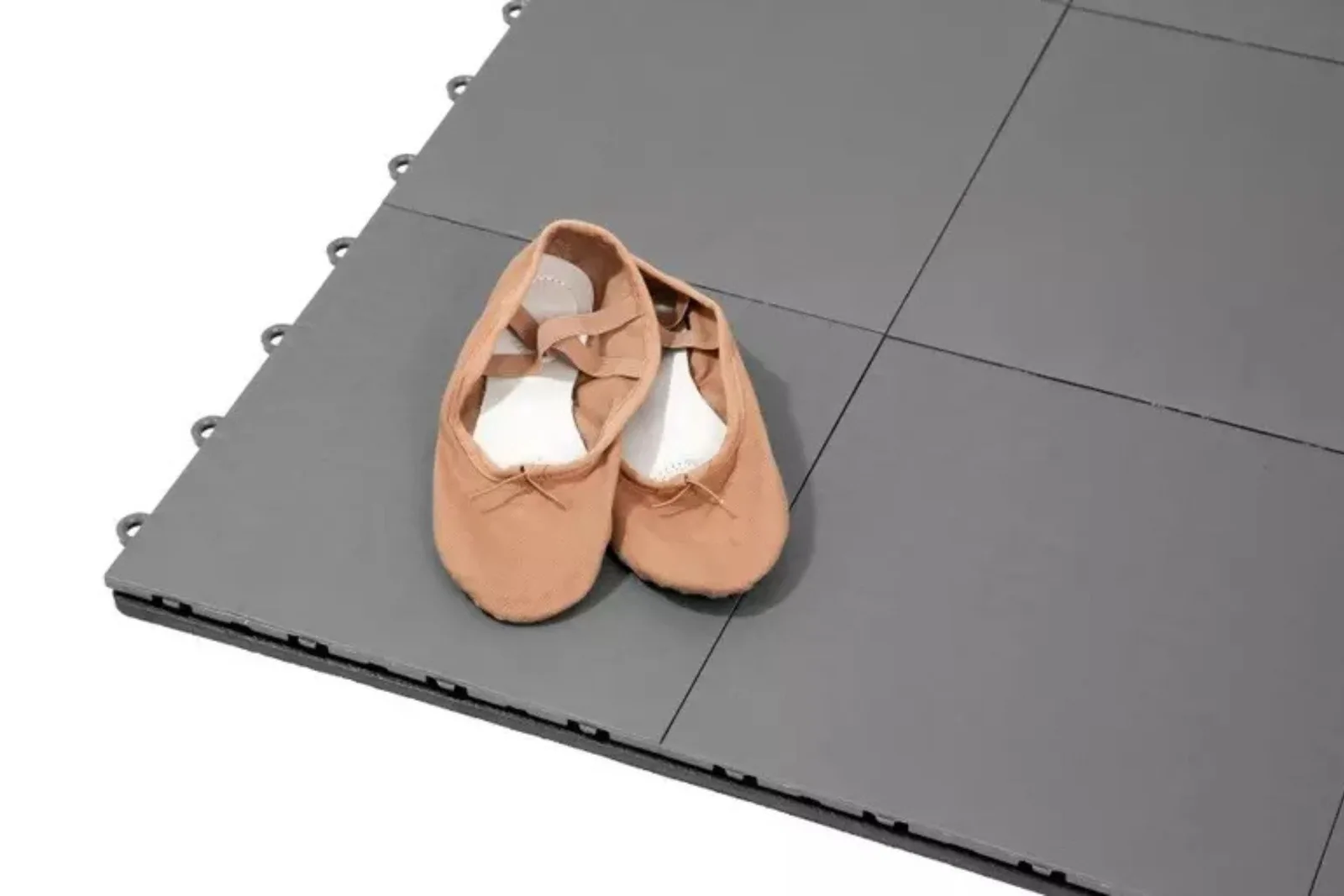 Ballet shoes on gray home dance subfloor kit.