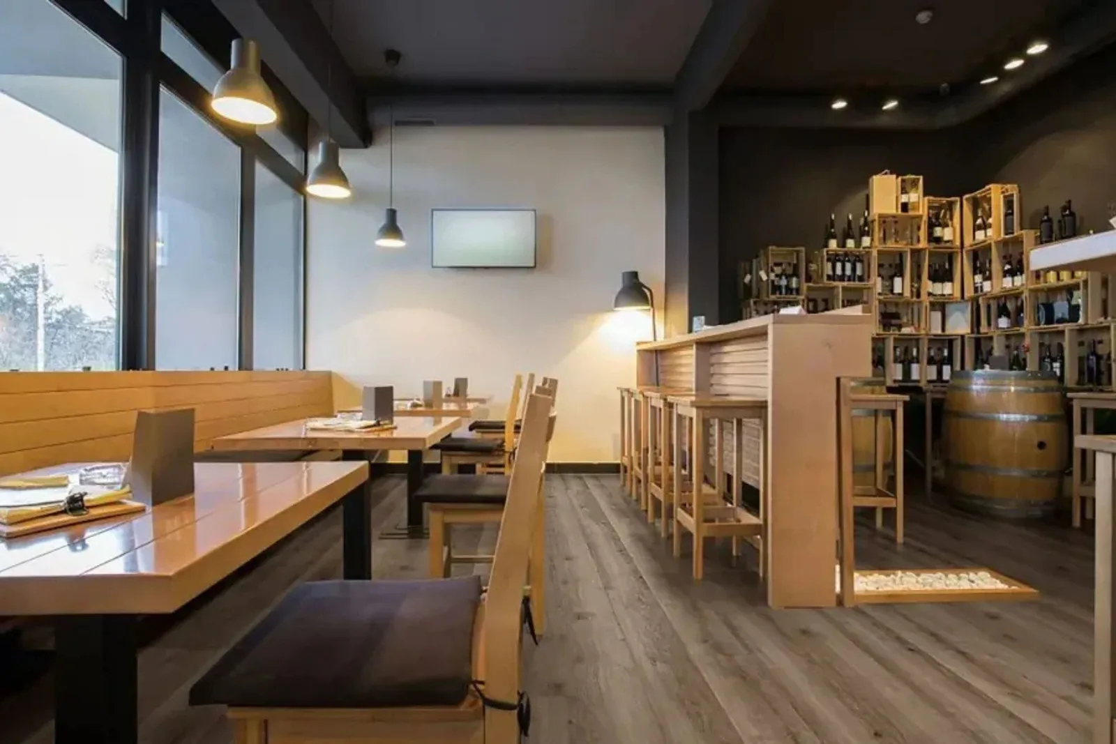 Modern restaurant with durable gray wood-look vinyl plank flooring, a water-resistant and easy-to-clean alternative to hardwood for commercial spaces.