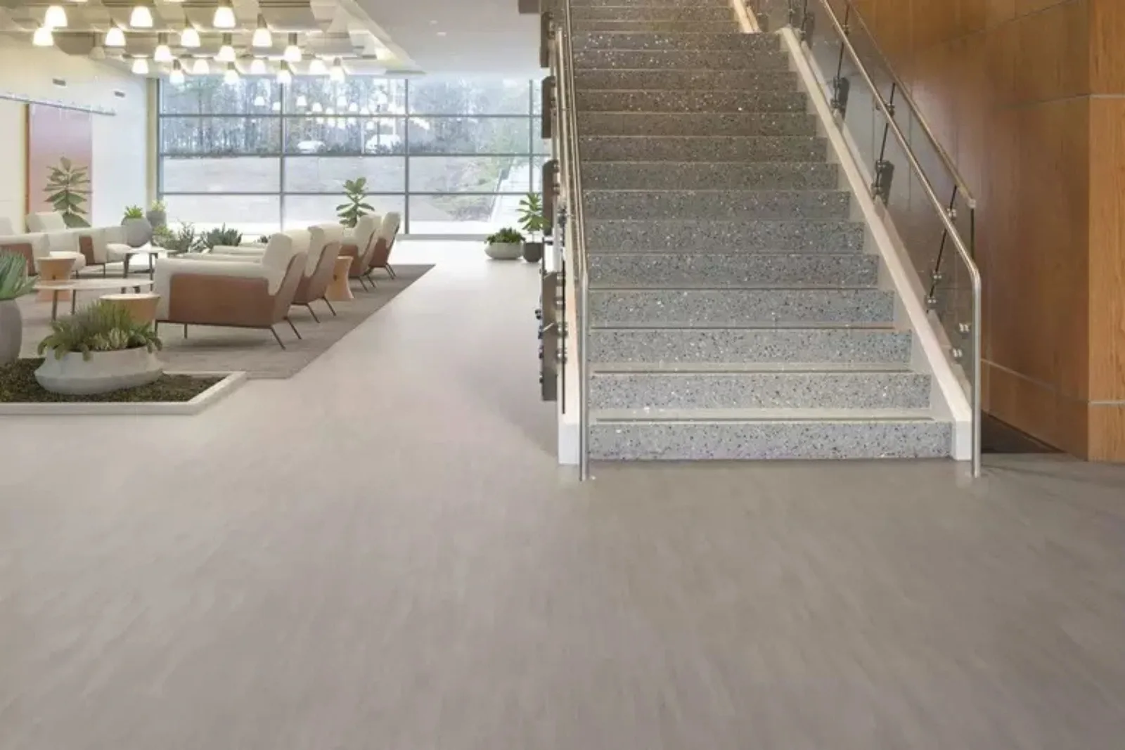 Modern commercial lobby with durable light gray luxury vinyl flooring, a stylish and long-lasting solution for a high-traffic business environment."
