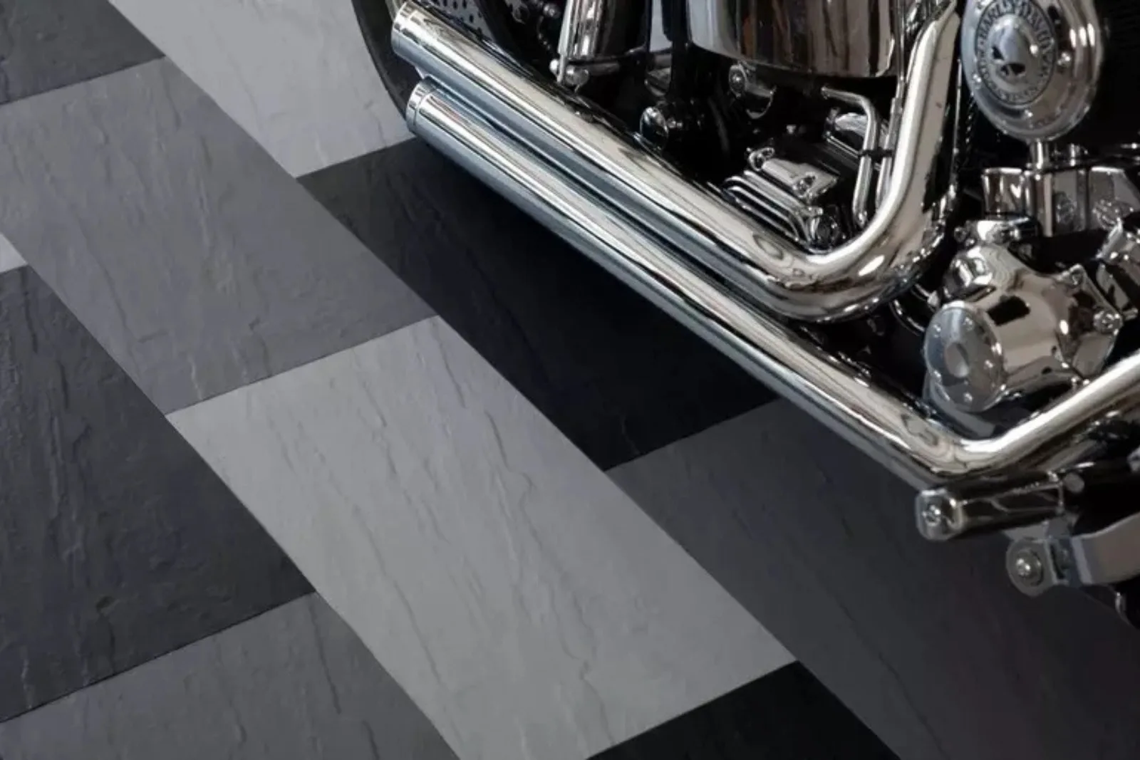 Black and grey interlocking garage floor tiles in a checkerboard pattern.
