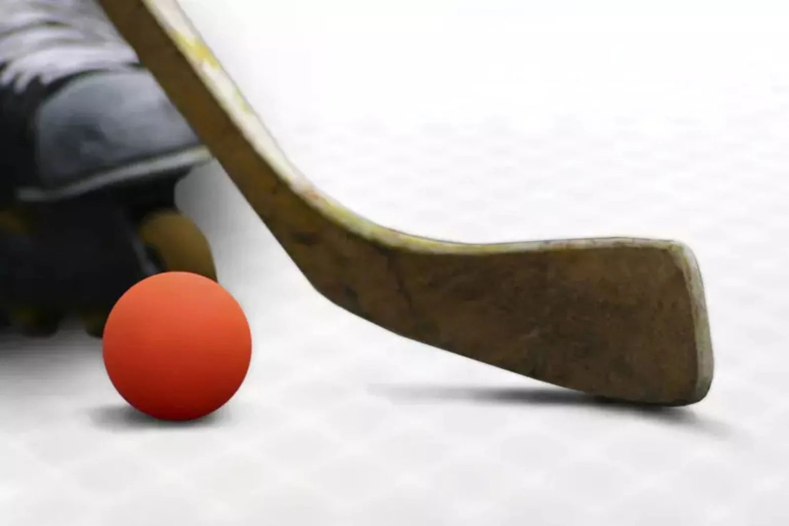 Interlocking indoor roller hockey rink tiles provide a high-performance, durable, and low-maintenance playing surface for in-line hockey, with a player's skate and stick visible.