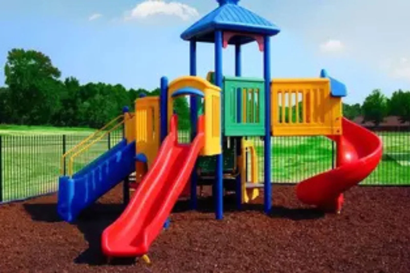 Brown Rubber Playground Mulch Brown rubber mulch creates a cushioned and shock-absorbent outdoor playground flooring suface for a colorful plastic playset, offering a safer alternative to wood mulch.