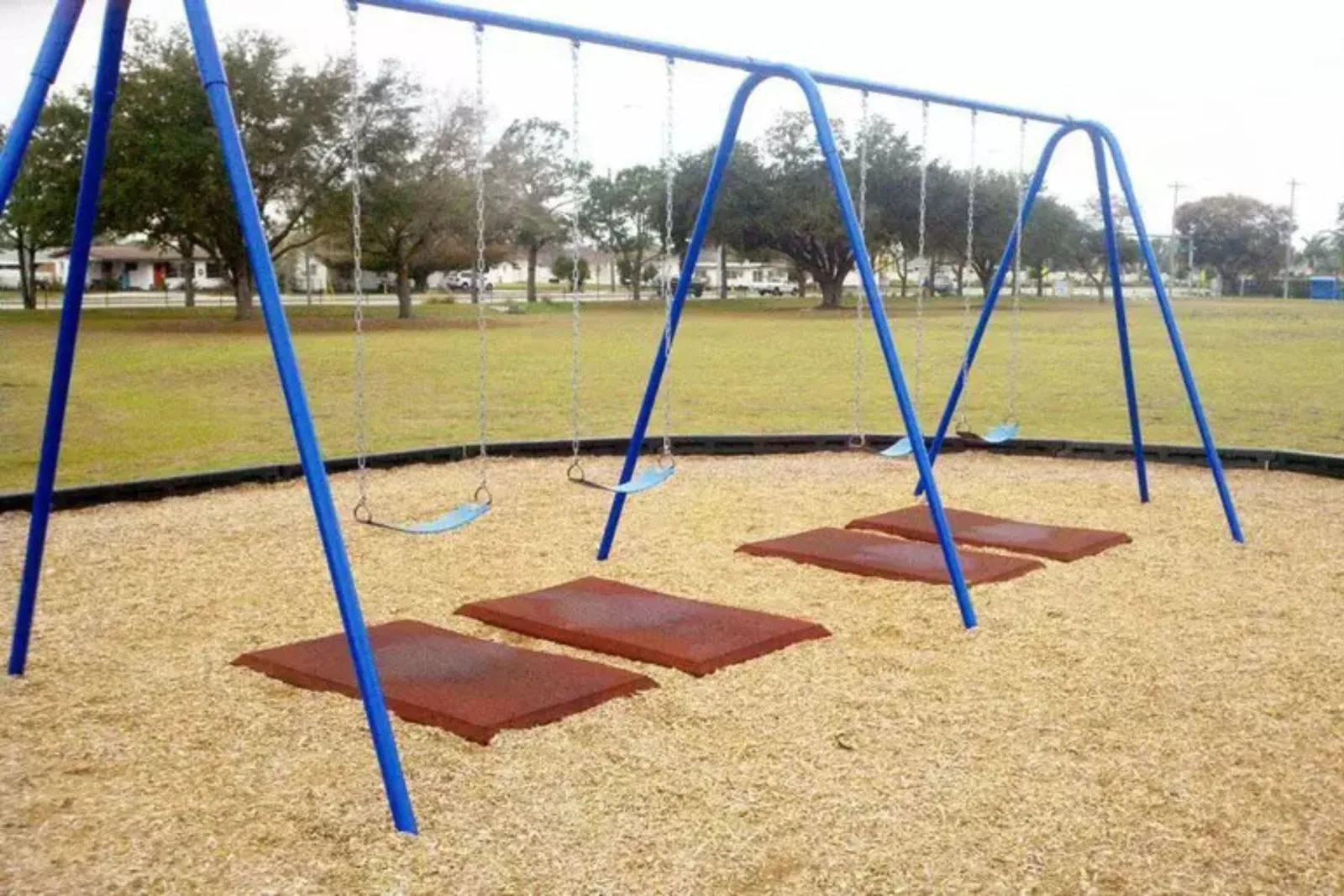 Playground Safety Swing Mats Rubber safety mats are used under a swing set in a playground, providing an extra layer of shock-absorbent and cushioned protection for kids in high-impact areas.