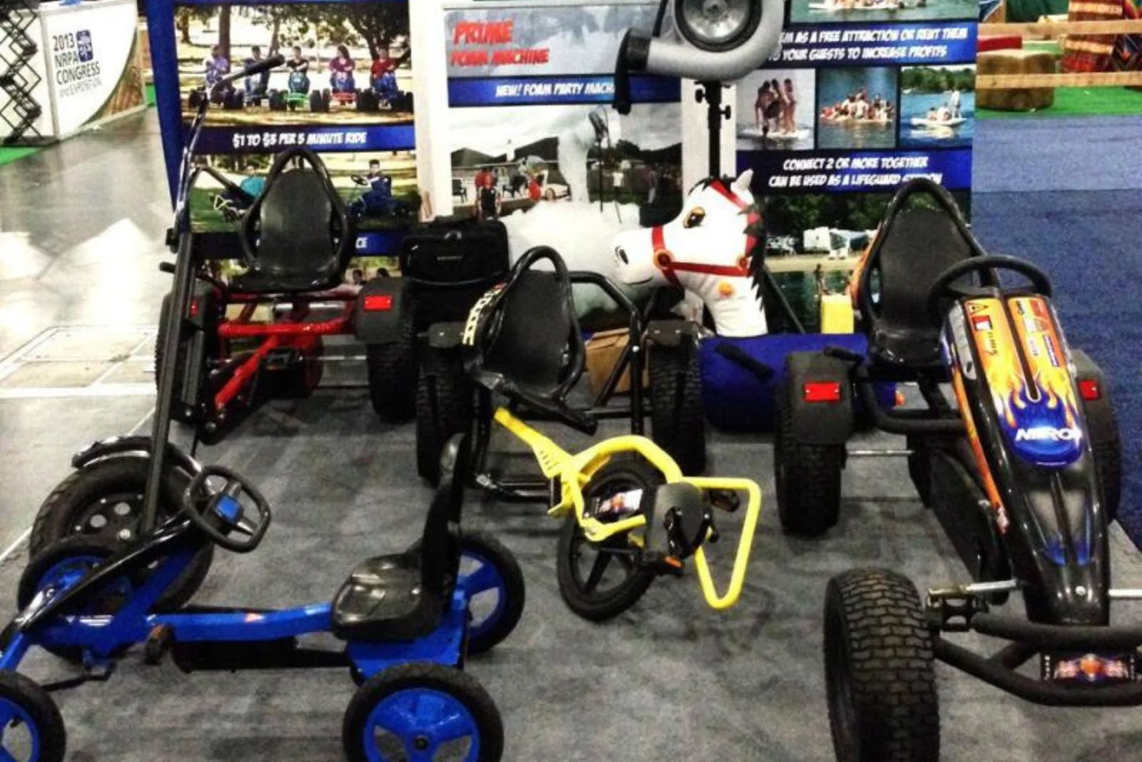 Durable foam carpet tiles in a trade show booth, creating a professional and comfortable event flooring solution for displaying products like go-karts.