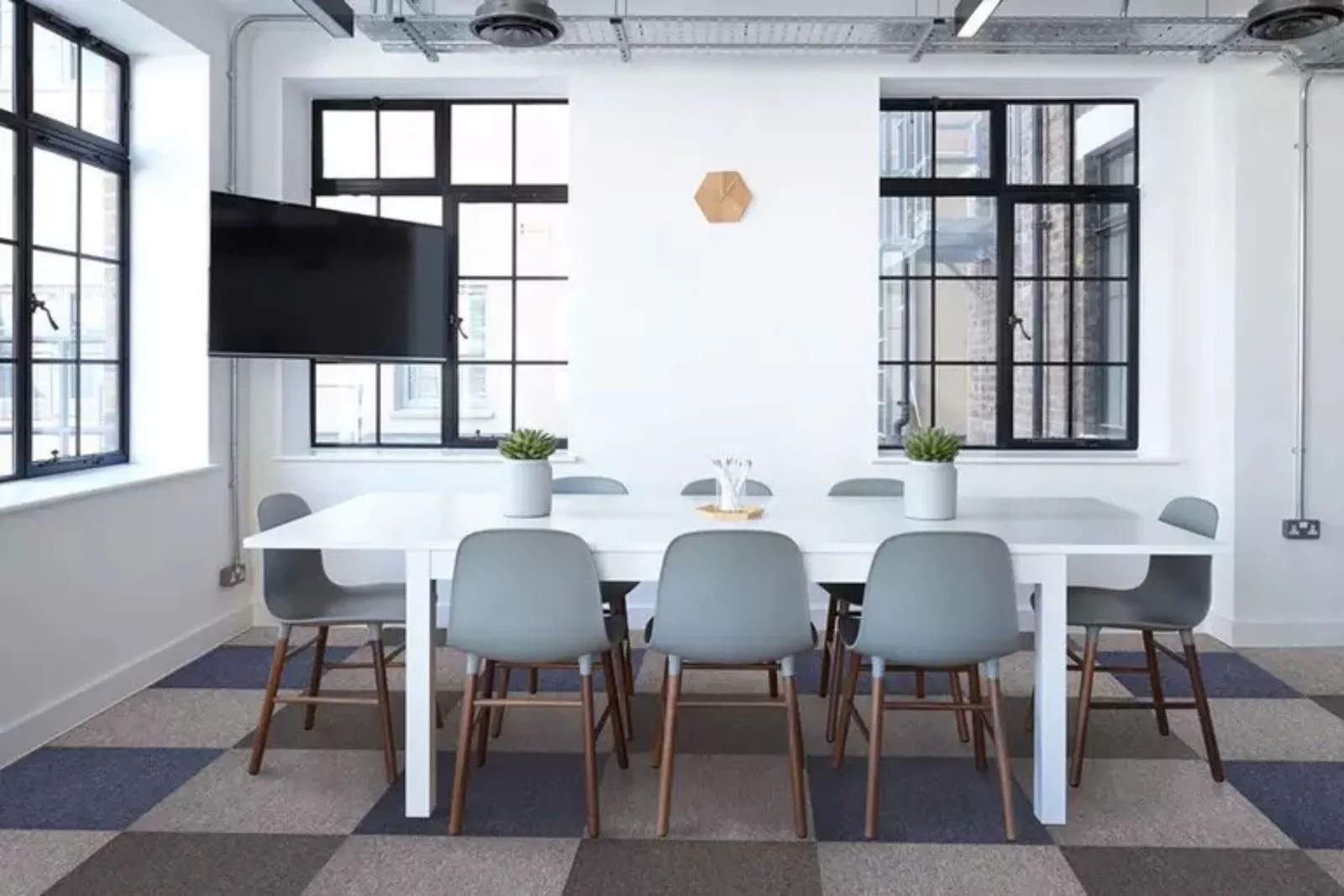 Modern office with stylish gray and blue patterned commercial carpet tiles, providing a durable and customizable flooring solution.
