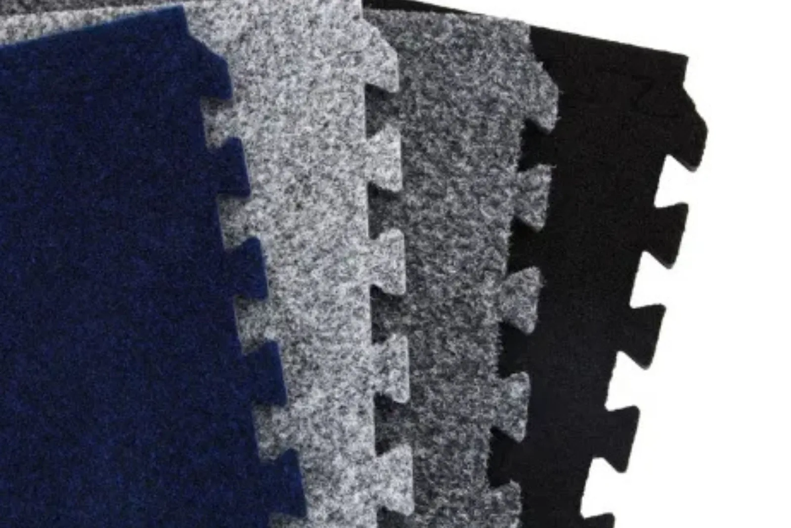 Stack of interlocking carpet tiles in multiple colors, including blue, light gray, dark gray, and black, a versatile flooring option.
