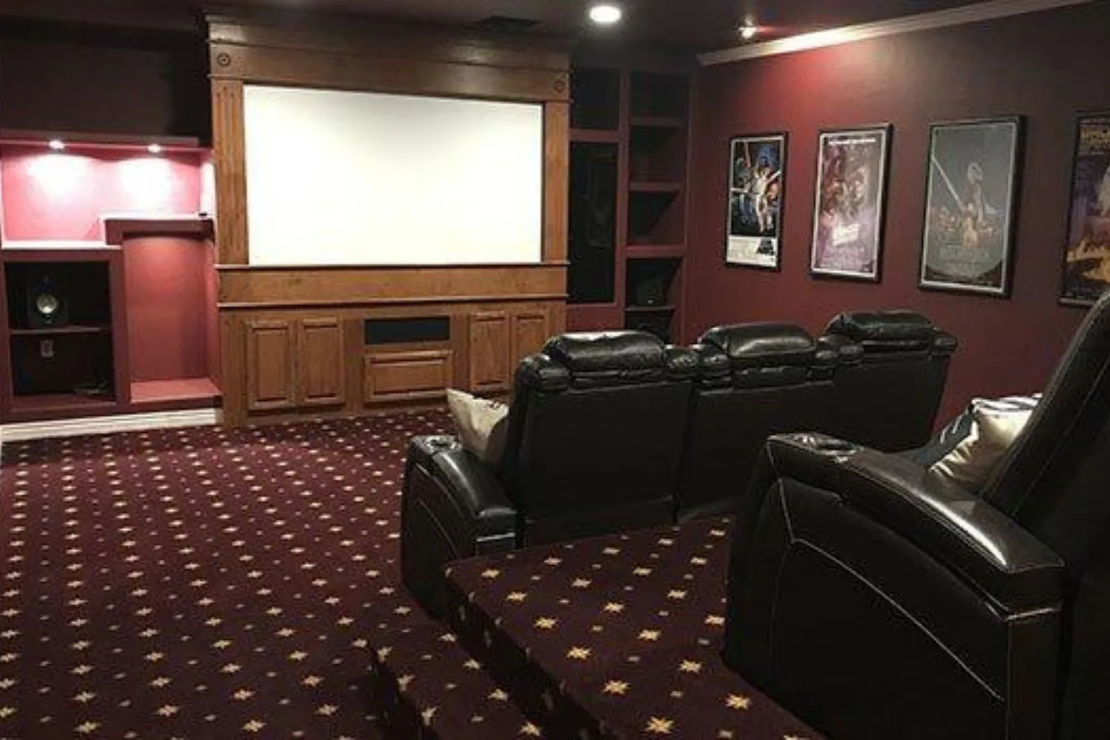 Luxury home theater with a dark red patterned carpet, a plush and stylish flooring solution perfect for creating a cozy atmosphere.