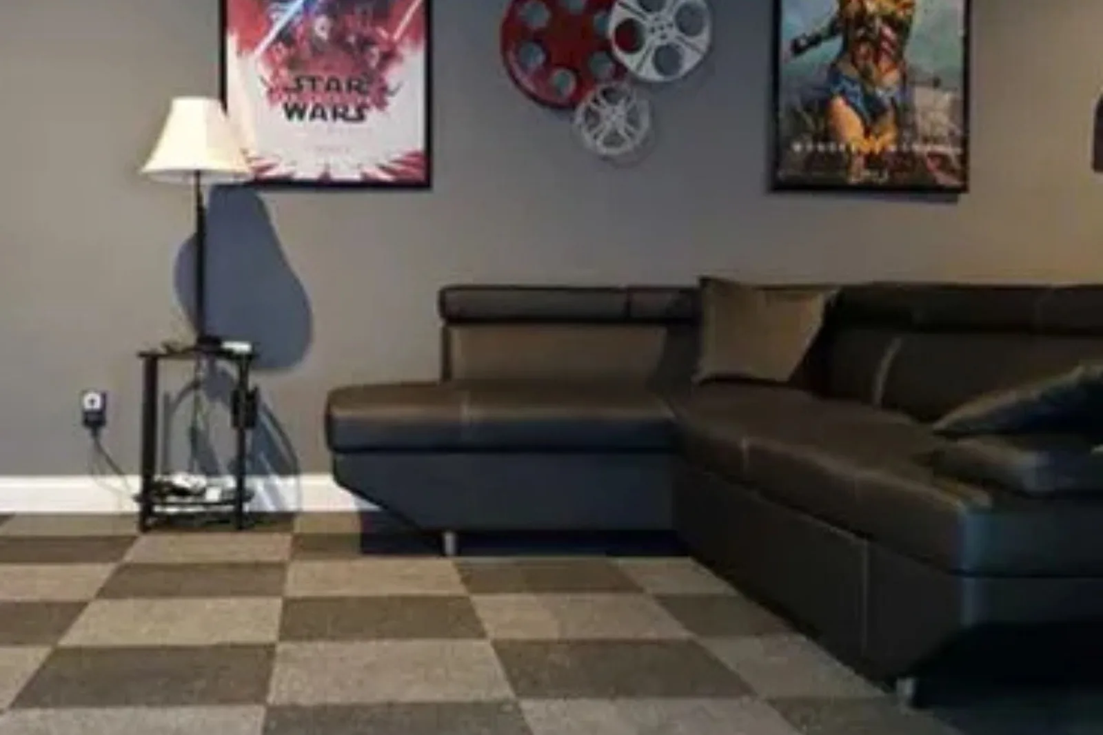 Home theater with a stylish dark gray and black checkered carpet, a comfortable and modern residential flooring solution.