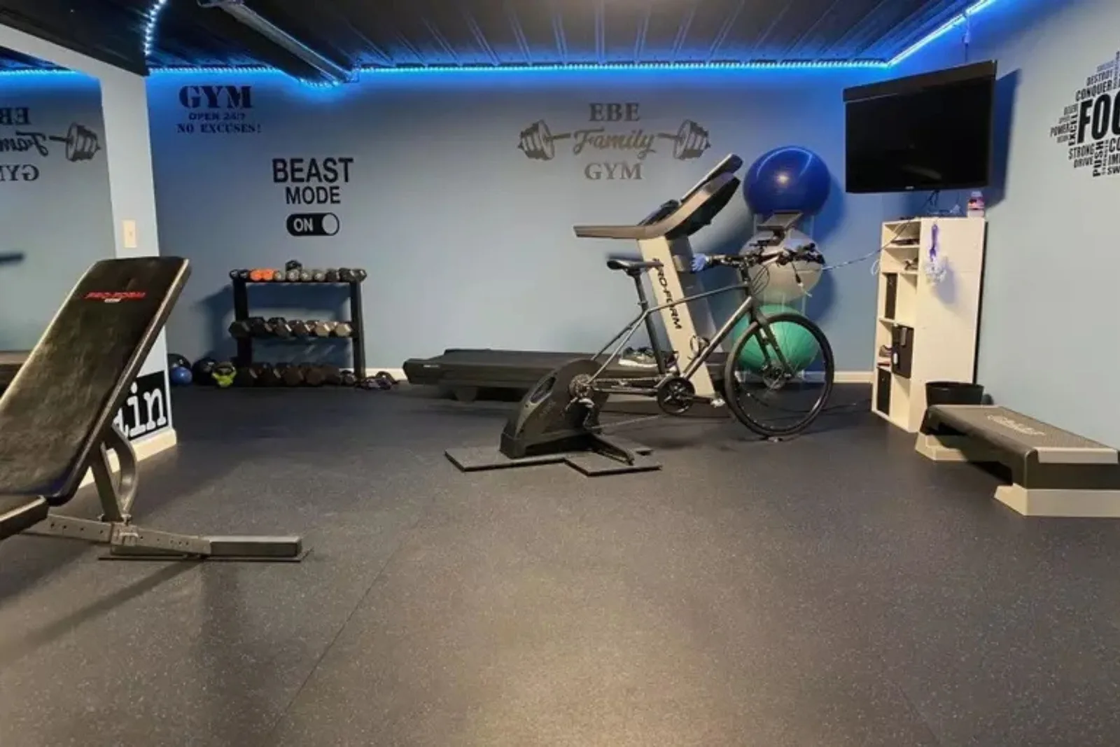 Durable black interlocking gym floor tiles Home gym with durable black rubber interlocking gym floor tiles, a protective and high-performance flooring solution for a workout space.