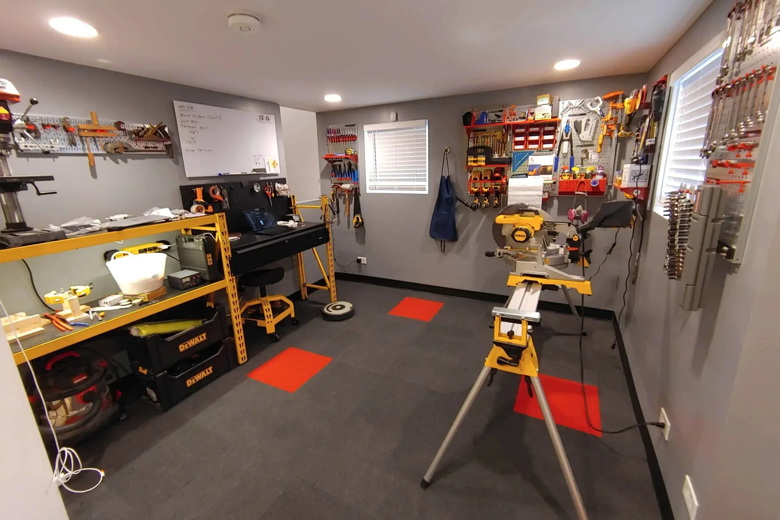 Durable interlocking garage floor tiles Home workshop or storage area featuring durable black and red interlocking garage floor tiles, providing a chemical-resistant and protective surface for tools and heavy equipment.