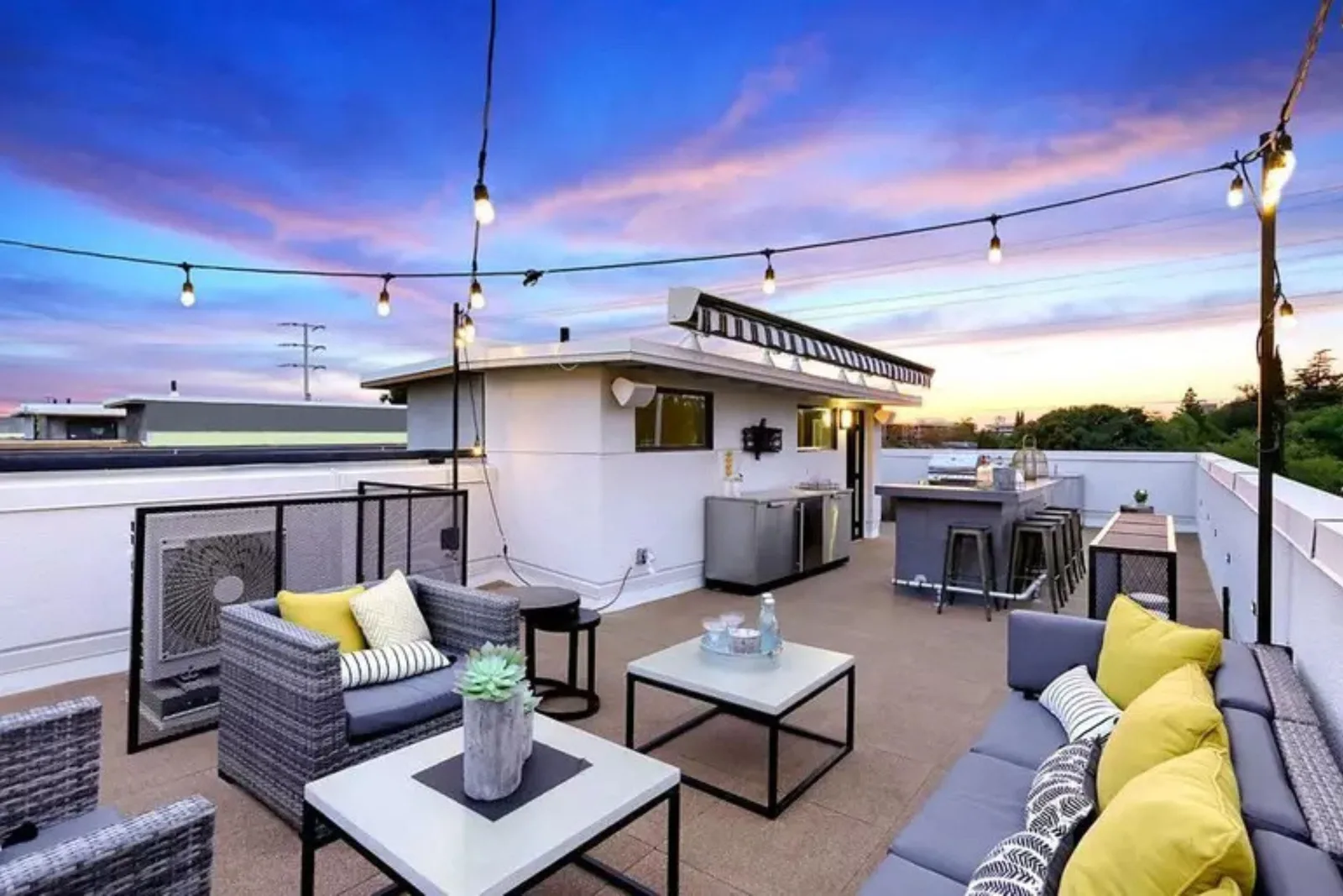 Durable interlocking rubber rooftop deck tiles create a stylish and weather-resistant outdoor living space with furniture and a grill, offering a low-maintenance flooring solution for balconies or rooftops.