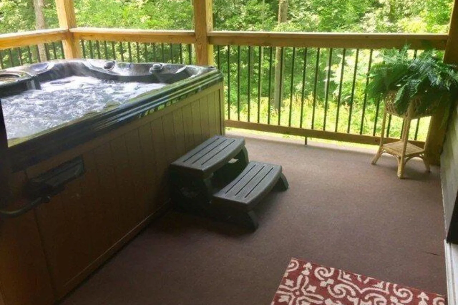 Outdoor carpet tiles patio flooring in a neutral brown color provides a comfortable, slip-resistant, and weather-resistant surface for a deck with a hot tub.