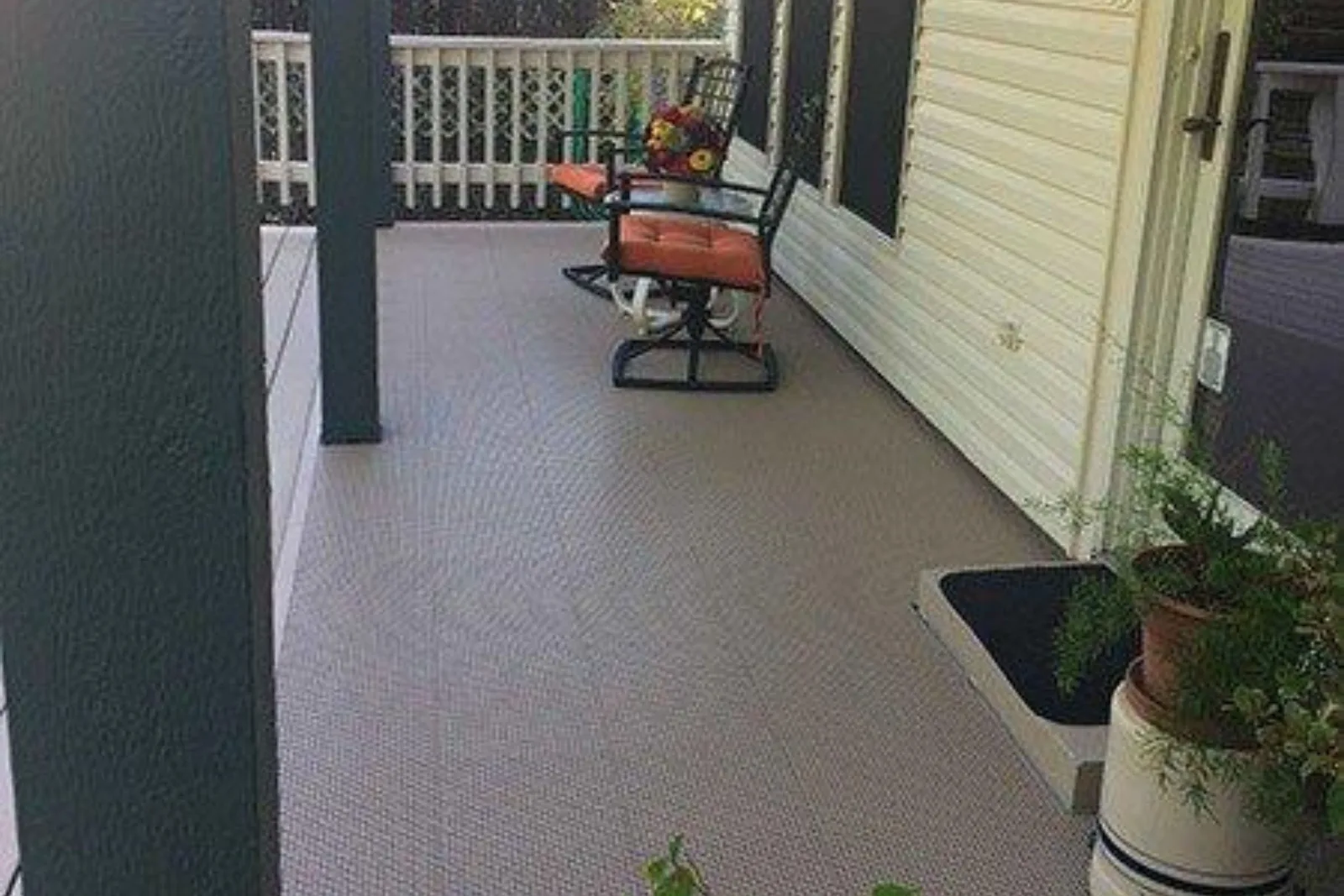 Rugged Grip-Loc garage floor tiles in a neutral gray color are used for an outdoor deck and porch, providing a durable and slip-resistant surface