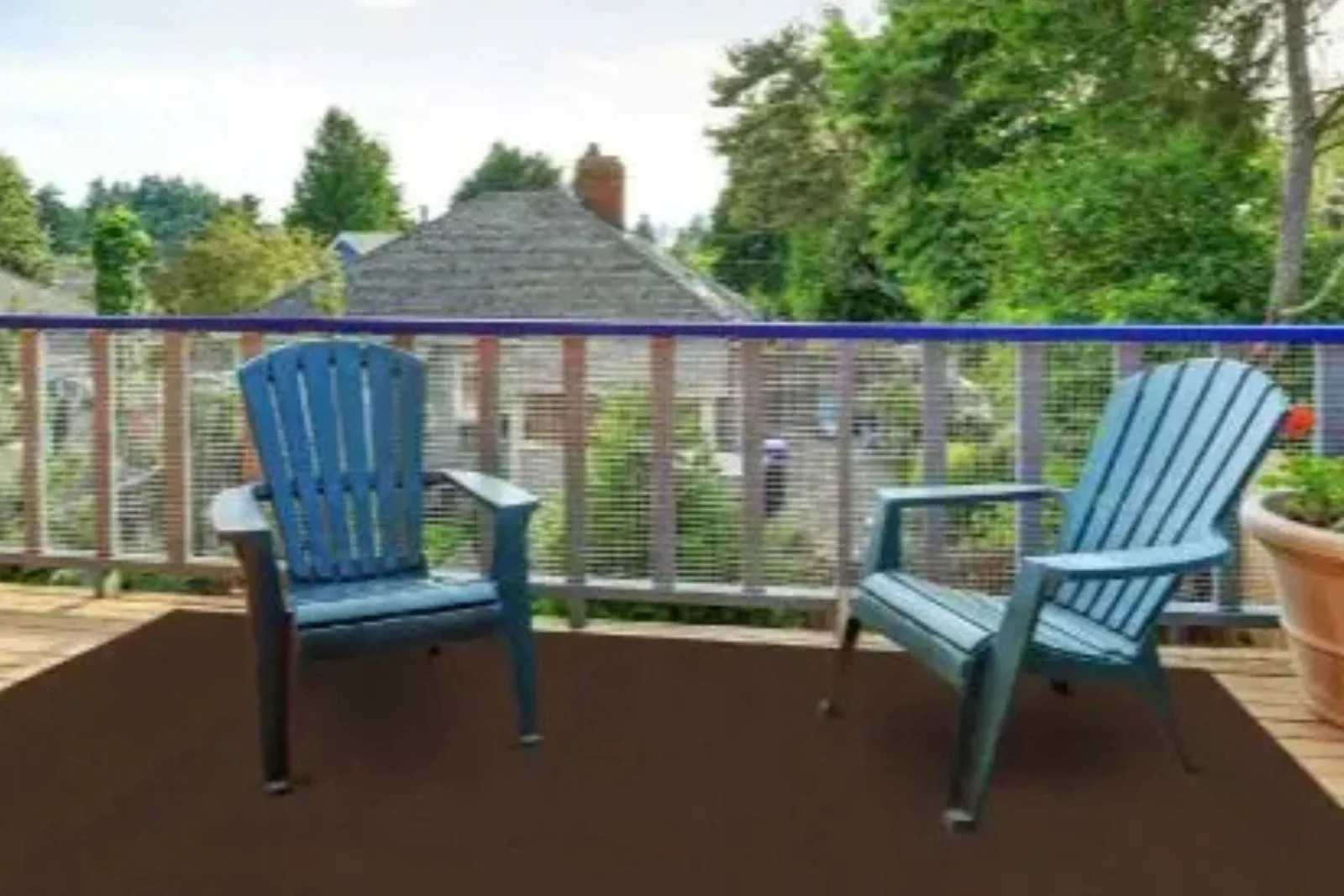Outdoor deck with a durable solid brown area rug, a versatile and weather-resistant flooring solution for outdoor spaces.
