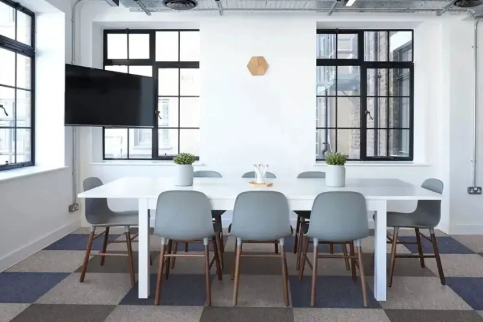 Modern office with stylish gray and blue patterned commercial carpet tiles, providing a durable and customizable flooring solution.