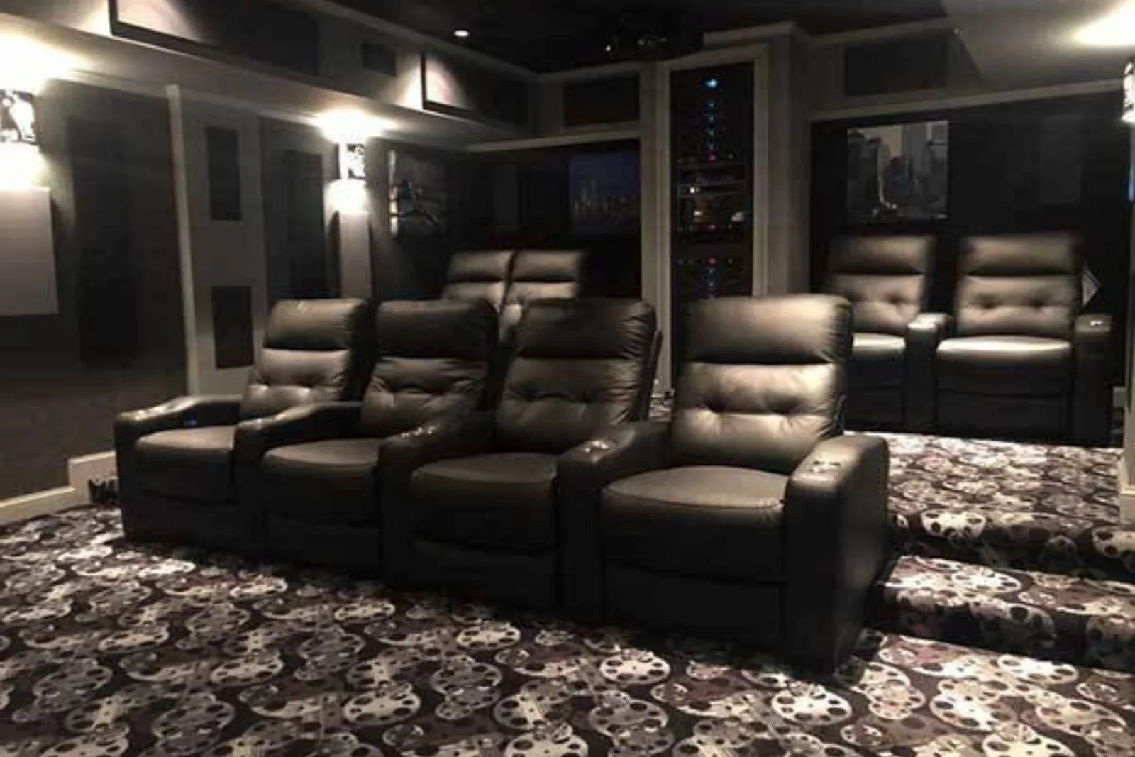 Luxury home theater with a stylish black and white film reel patterned carpet, a plush and unique flooring solution for entertainment spaces.