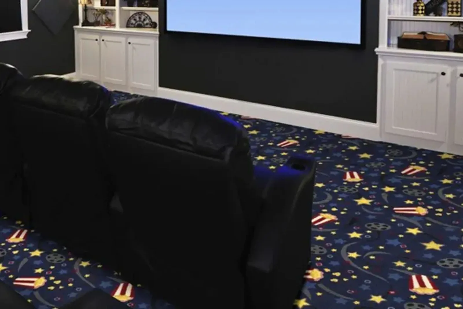 Fun home theater with a colorful patterned carpet featuring popcorn, stars, and film reels, a unique and comfortable residential flooring option.