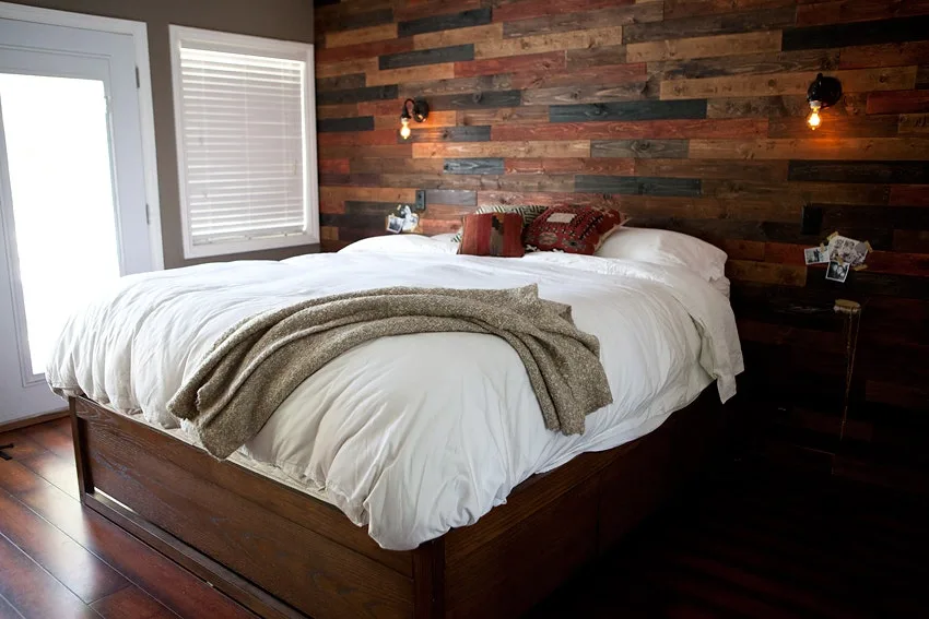 Bedroom with a reclaimed wood plank accent wall behind the bed