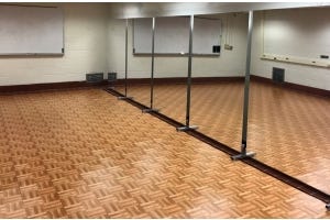 dance floor tiles in a dance studio in front of a wall of mirrors