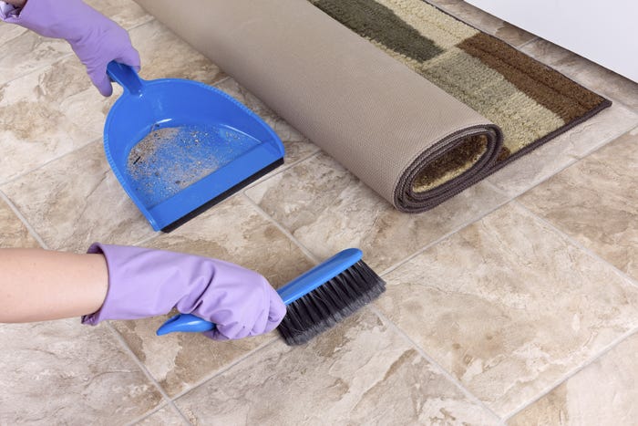Flooring Inc. Tile Cleaning Guide: sweeping tile with a broom and dustpan